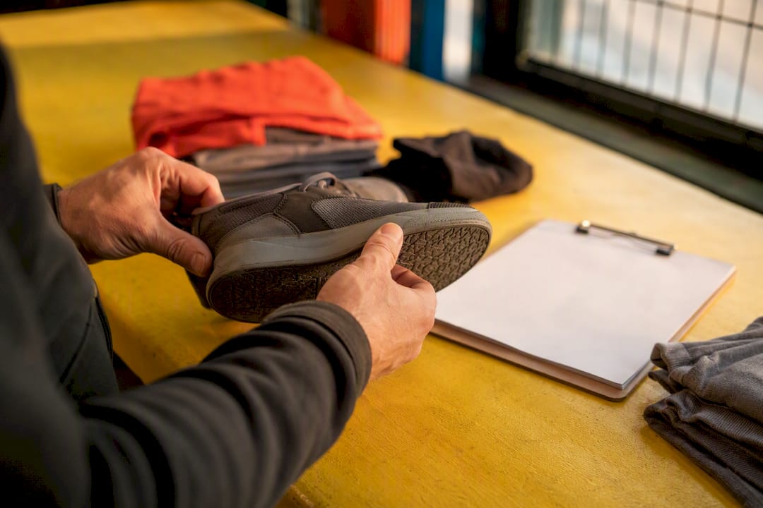 Hands inspecting shoe interior closely