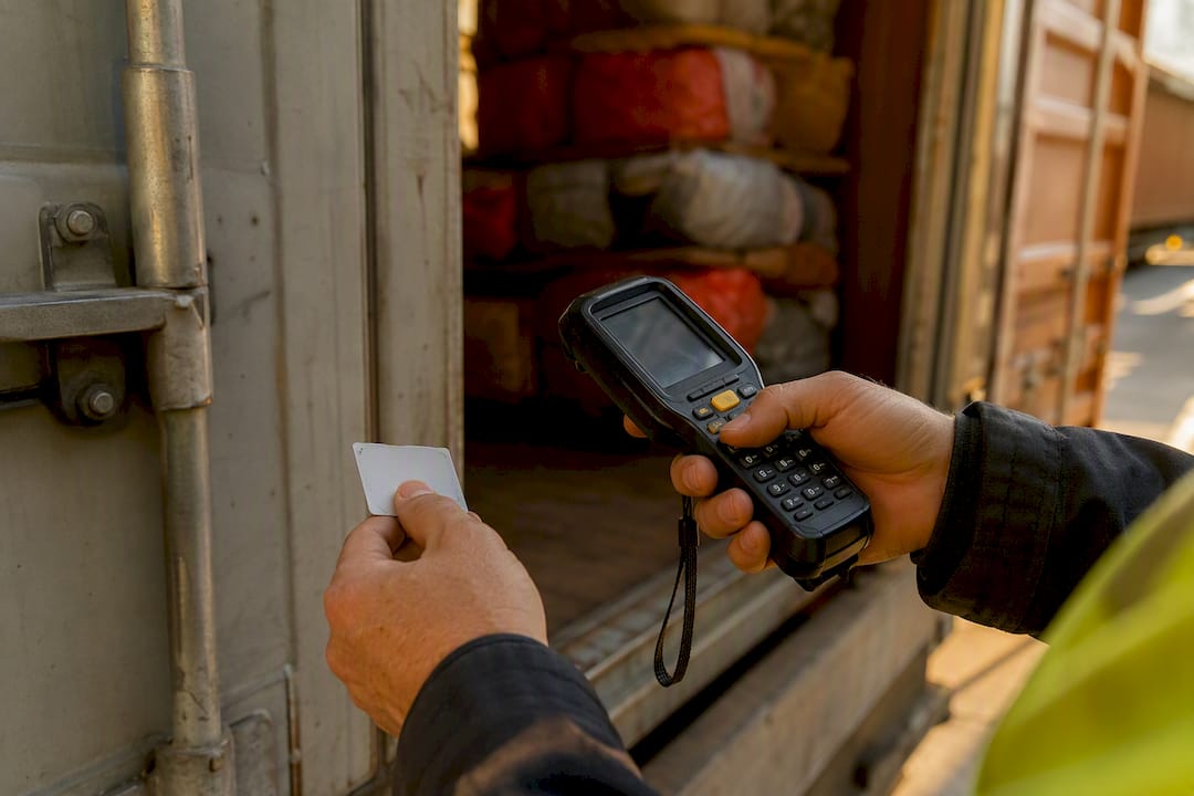 Hands scanning shipping container code