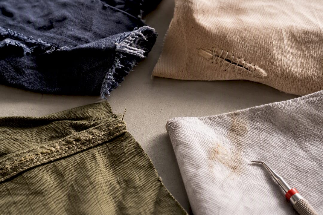 Close-up of frayed and repaired textile fibers