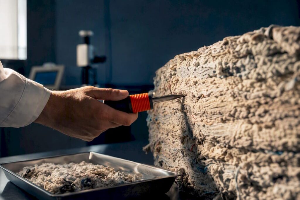 Technician testing moisture in compressed textiles